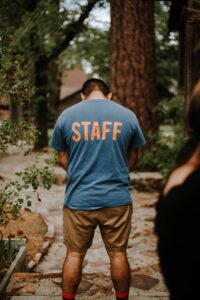 a man standing in front of a forest