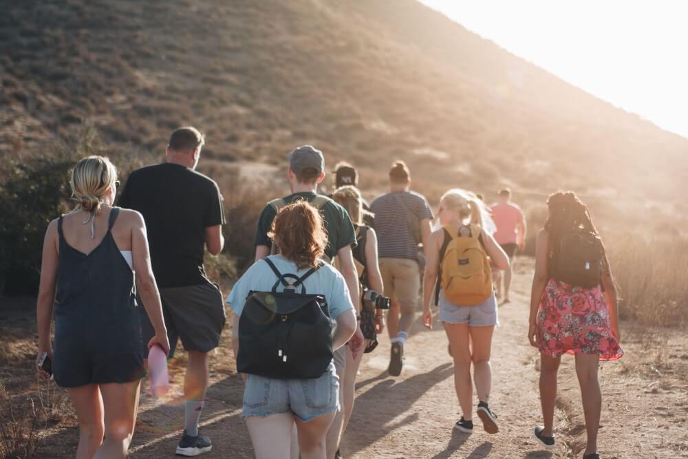 a group of people standing on a beach