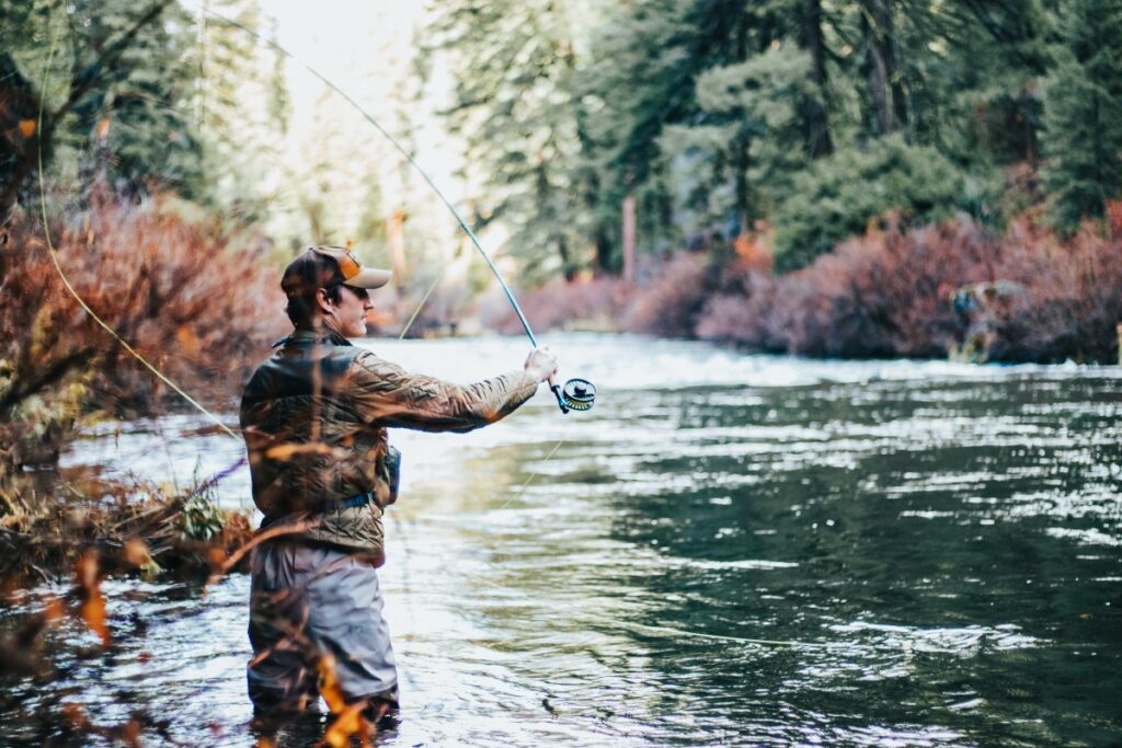 man in wilderness fly fishing