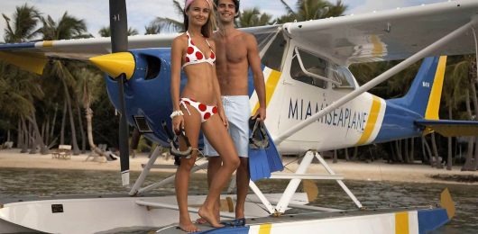 a woman standing next to a plane